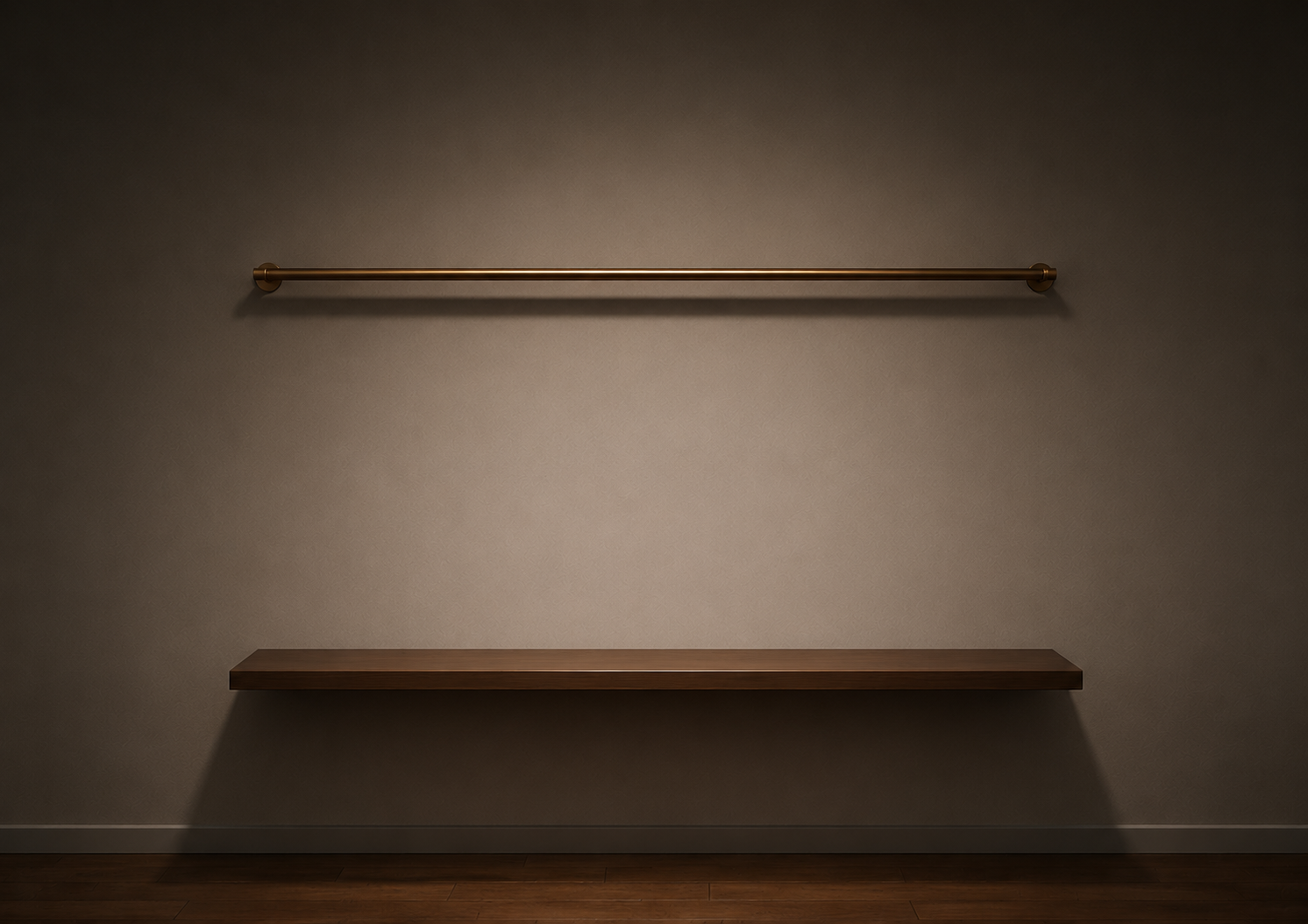 A brass rail and a wood shelf mounted on a warm-lit gallery wall